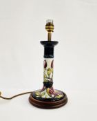 Moorcroft pottery table lamp of candlestick form, mounted on a wooden base, decorated pink