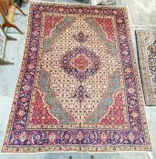 Northwest Persian cream ground Tabriz carpet with central floral medallion on floral field to