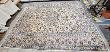 Central Persian cream ground Kashan carpet with large ivory central floral medallion on herati