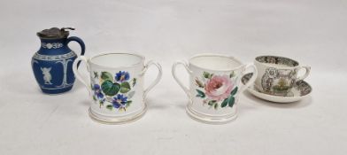 Pair of 19th century English porcelain two-handled motto loving cups, each painted with flowers,