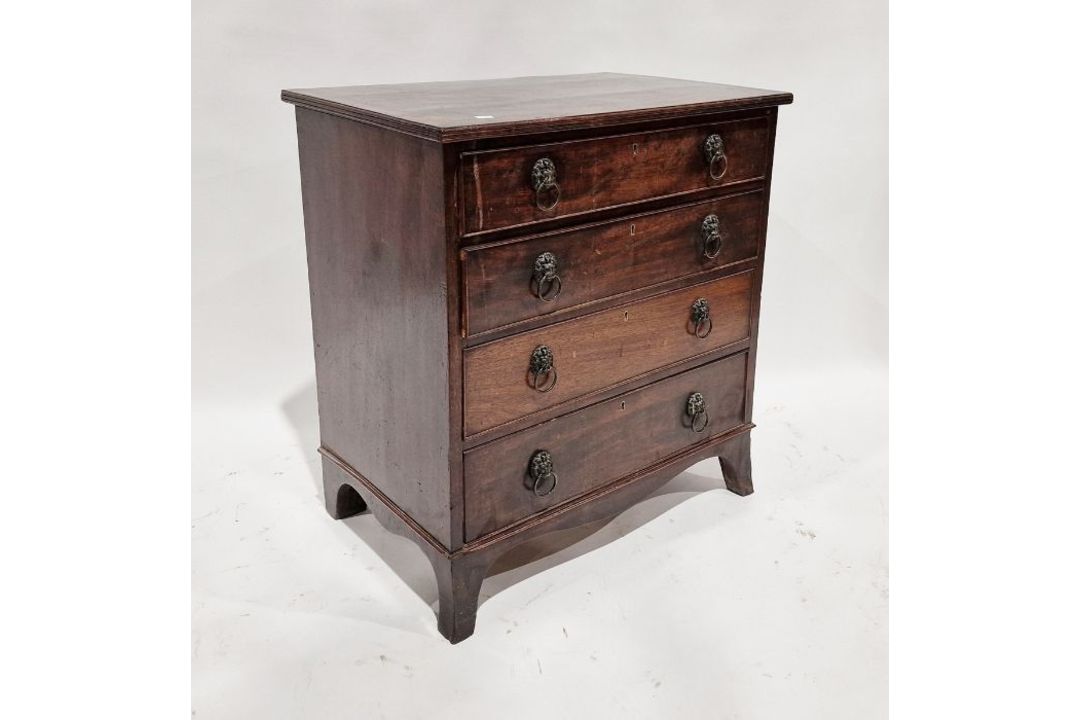 19th century mahogany chest of four long drawers with brass lion hoop handles, on splayed