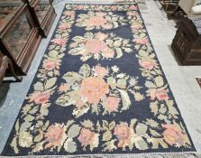 Modern Oka black ground kilim with three central floral medallions, single floral border 335cm X