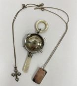 Silver and mother-of-pearl baby rattle, a silver ingot pendant on chain, 33.5g and a silver-coloured