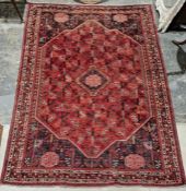 South west Persian red ground Qashgai carpet with central lozenge medallion on geometric field,