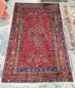 North west Persian red ground Zanjan rug with central hexagonal medallion on field of stylized