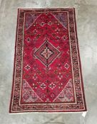 Central Persian red ground Josheghan rug with central geometric medallion in floral field, herati