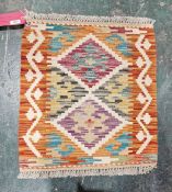 Chobi orange ground small kilim with central diamond medallions and geometric border, 55cm x 49cm
