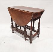 Antique oak gateleg dining table, oval on baluster supports, cross-stretchers opening to 108cm