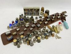 Quantity of assorted thimbles, some silver and silver-coloured metal, wooden, glass, enamel, one