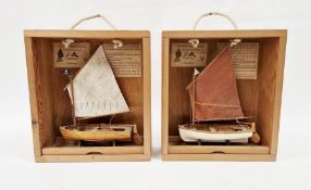 Small wooden model of Arthur Ransome Amazon boat and another of Swallow on wooden stand