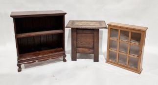 Carved oak occasional table with lift-up top, foliate and roundel carved, on panelled base a