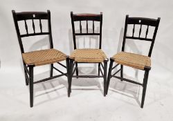 Four ebonised and cane-seated chairs (4)