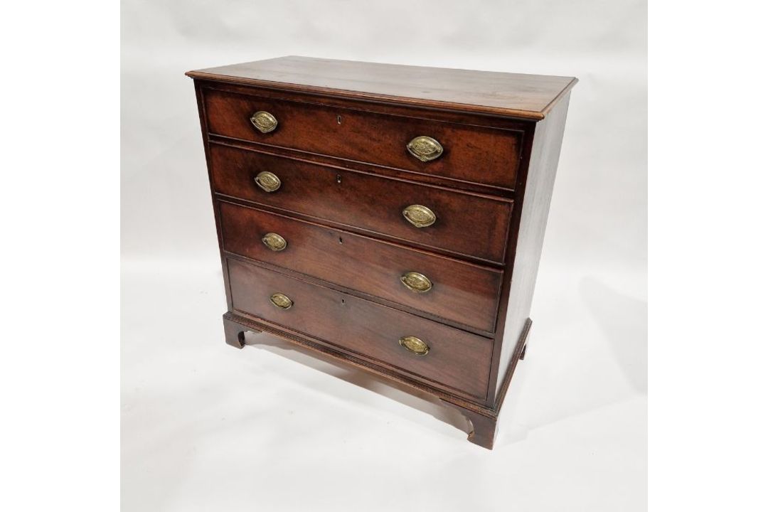 19th century mahogany chest of four long graduating drawers, with brass oval plate handles, on
