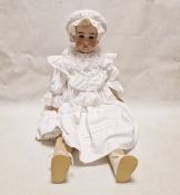 German doll with bisque head, sleeping blue eyes, open mouth and teeth, stuffed legs and body in a