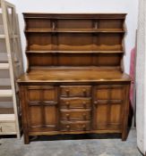 Ercol dark elm dresser with shelved back, cupboards and drawers, 145cm wide