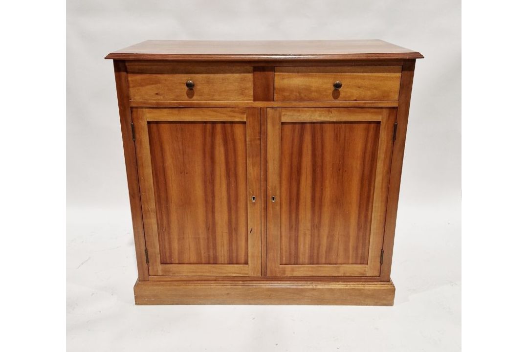 Modern oak sideboard with two drawers (one dummy drawer) above pair of cupboards below, on plinth