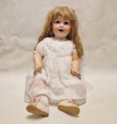 Bisque headed doll marked 'PM' and having blue sleeping eyes, open mouth, composition body, 71cm