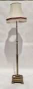 Early 20th century brass standard lamp, with reeded lower section, stepped base raised on square