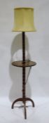 Early 20th century turned oak standard lamp with central tier on tripod base