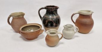 Winchcombe pottery slip-glazed jug, glazed in dark brown and decorated with a band of wave ornament,