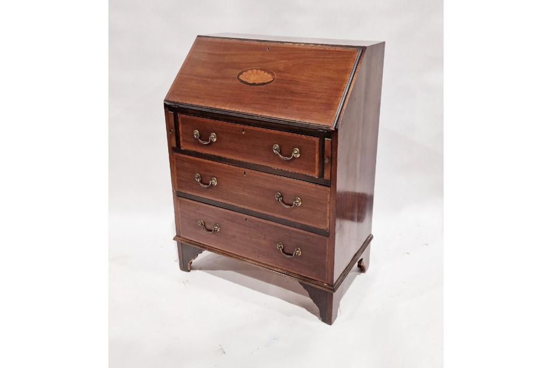 Edwardian mahogany inlaid bureau, the fall front enclosing drawers and pigeonholes, on three long