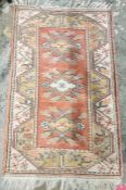 Modern red ground wool pile rug with three floral medallions to floral border 132cm x 84cm