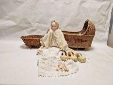 Bisque headed doll with fixed blue glass eyes, in christening robe and cream wool cape, three