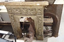 Early 19th century cast iron fire surround, the pattern showing birds, a mask and floral
