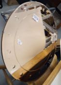 Art deco style brown/orange tinted circular wall mirror with engraved convex lens border