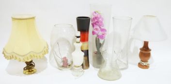 Two glass vases, one with a faux orchid, an ovoid-shaped vase with stars on the side, an alabaster