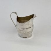 George III silver cream jug, helmet-shape with reeded tapering handle, bright cut floral engraved,