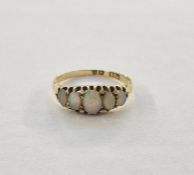Gold-coloured metal and opal dress ring set five graduated opals, claw set (some wear to the