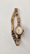 Lady's Rotary 9ct gold wristwatch with oval champagne face, on integral pierced rectangular link