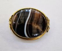 Gold-coloured metal and oval banded agate brooch, 6cm x 5cm approx.