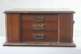 A late 19th century walnut Elkington table top canteen cabinet with locking stiles and twin brass