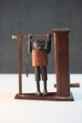 A Meji period Japanese Kobe painted and carved swinging man automaton. With protruding eyes and
