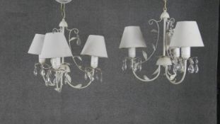 A pair of toleware foliate design three branch chandeliers with crystal drops. H.40 W.42cm