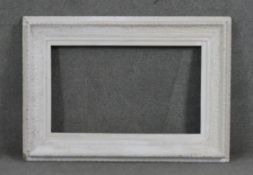 A large 19th century carved and painted picture frame with shell and foliate motifs. H.83 W.117cm