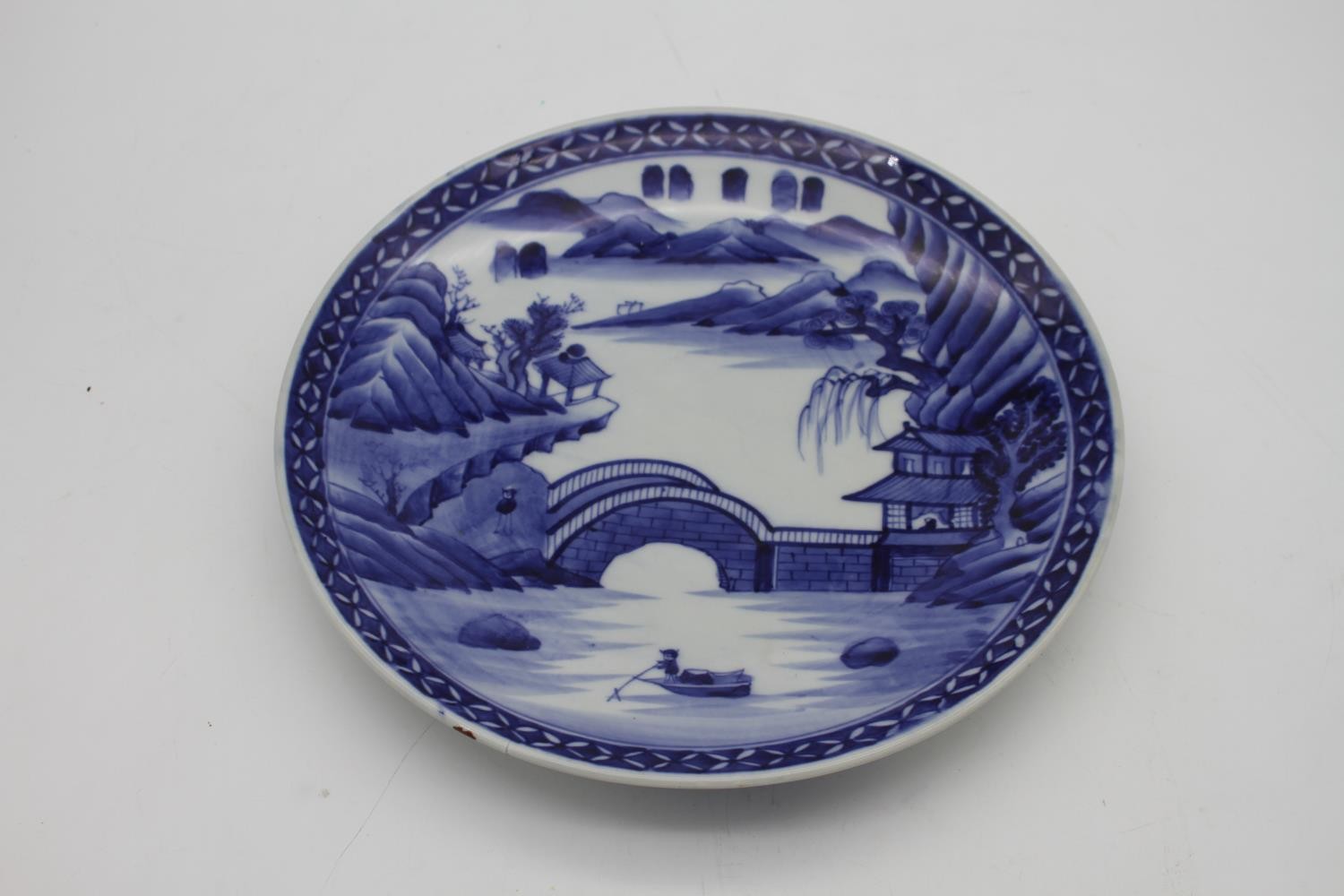 A pair of Japanese Arita style porcelain blue and white chargers hand painted with a landscape - Image 2 of 5