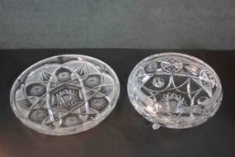 Two hand cut crystal bowls. One on three feet and one large serving dish. They both have a