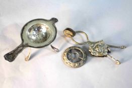 A Victorian silver plated skirt lifter with an urn and fruit design along with a Danish silver