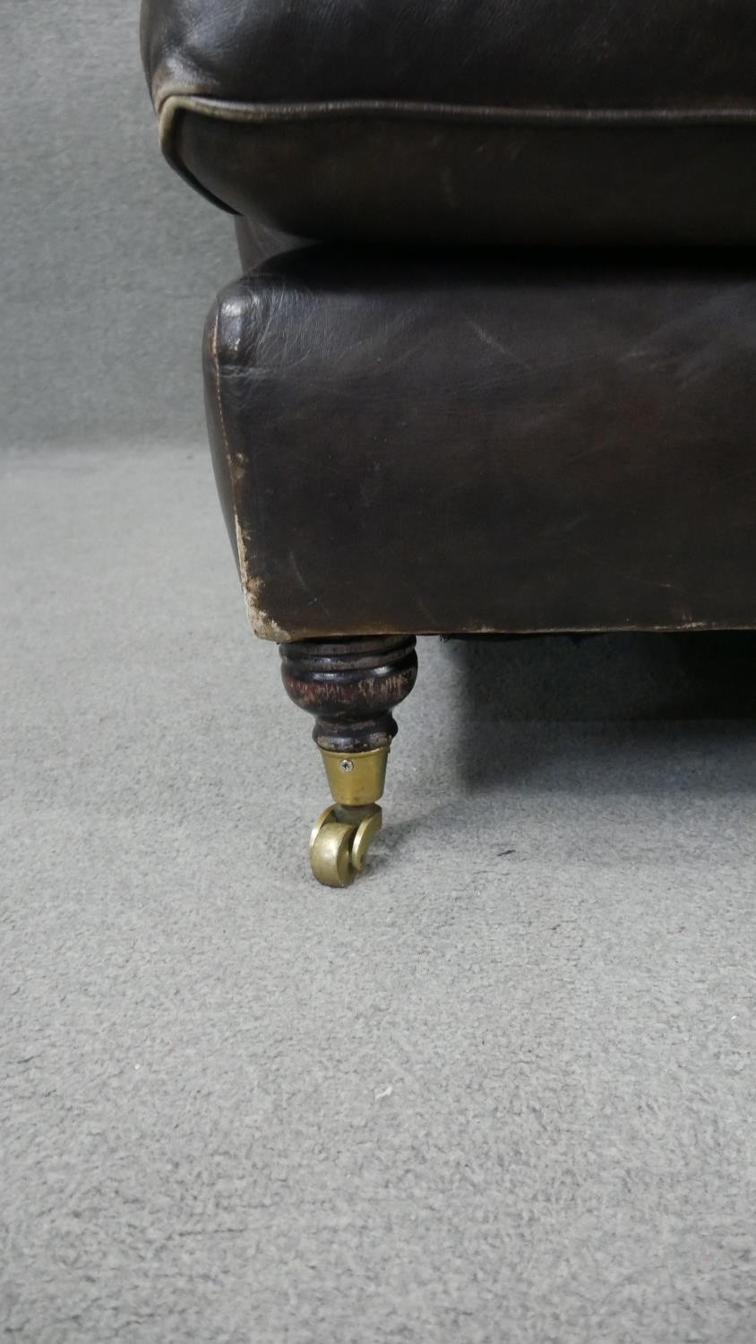 A Howard style two seater sofa in leather upholstery on turned supports terminating in brass - Image 4 of 7
