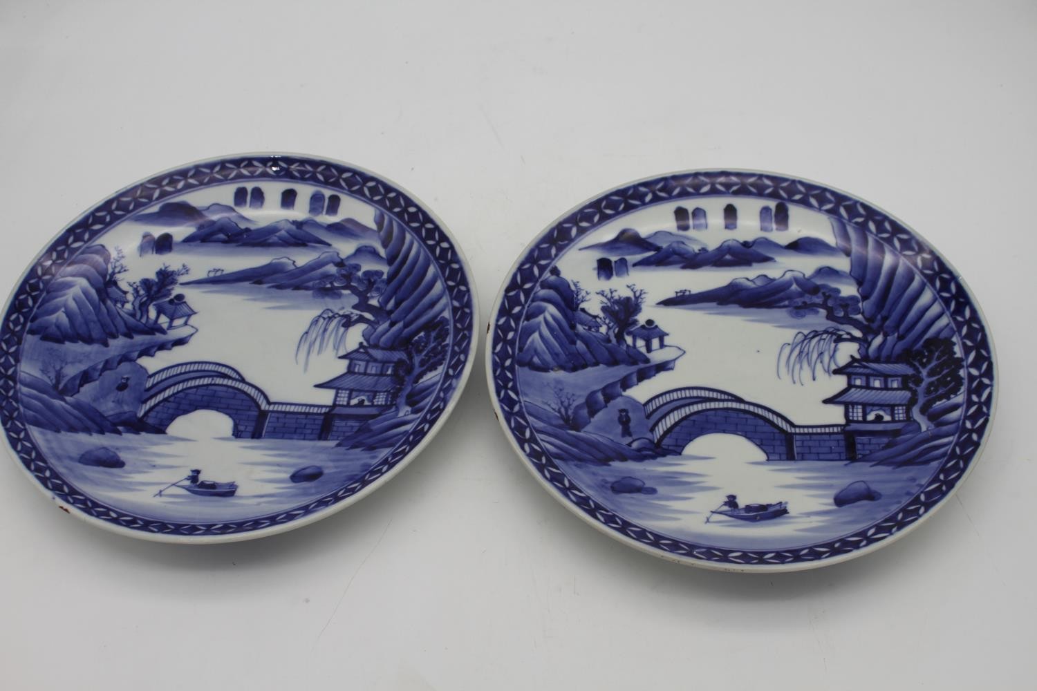 A pair of Japanese Arita style porcelain blue and white chargers hand painted with a landscape - Image 3 of 5