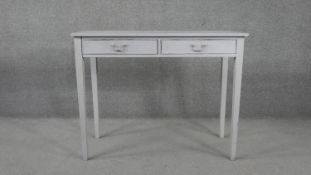 A 19th century distressed painted side table with two frieze drawers on square tapering supports.
