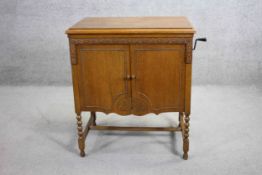 An early 20th century oak cased Geisha Gramaphone by Gilbert and Co along with a collection of 78