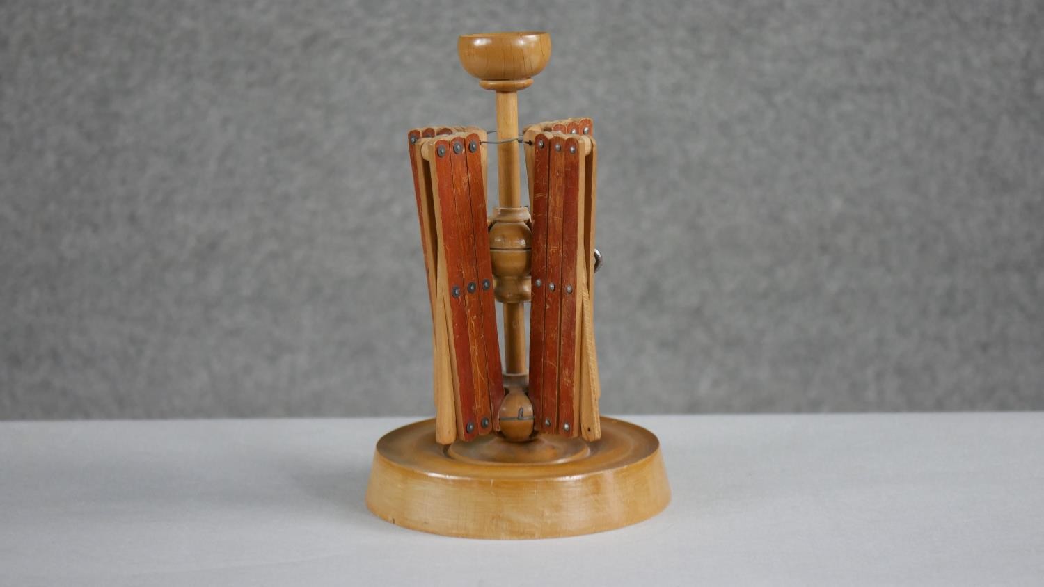 A 19th century treen wool spinner with four extending arms and a turned circular base. H.23 W.