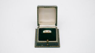A vintage three stone carved half hoop 18 carat yellow gold opal and diamond ring. Set with three