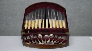A early 20th century mahogany velvet lined cased part six person canteen of cutlery by various