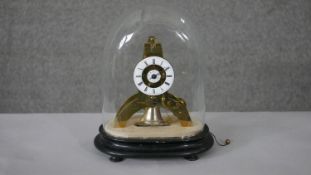 A small French brass skeleton clock with alarm, the white enamel chapter ring enclosing a central