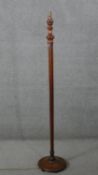 A mid century vintage mahogany standard lamp with faceted column on platform base. H.158 Diam.30 cm